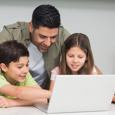 Father-with-young-kids-using-laptop-in-kitchen.jpg